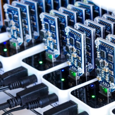 Bitcoin mining USB devices in a row with small fans.
